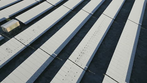 solar panels of solar power plant covered in snow and ice, drone shot, slow movement forward