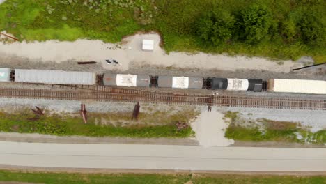 4k-top-down-footage-panning-left-to-right-of-train-moving-down-the-track