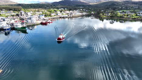 Drone-small-car-ferry-sailing-out-of-Castletownbere-harbour-Ireland-to-Beare-Island-early-morning-in-summer