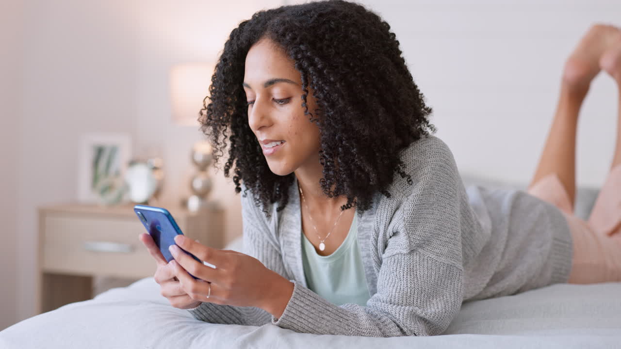 Social media, phone and bed with young black woman