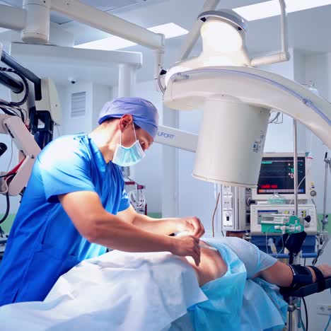 specialist performing operation. surgery process on the background of modern medical equipment.
