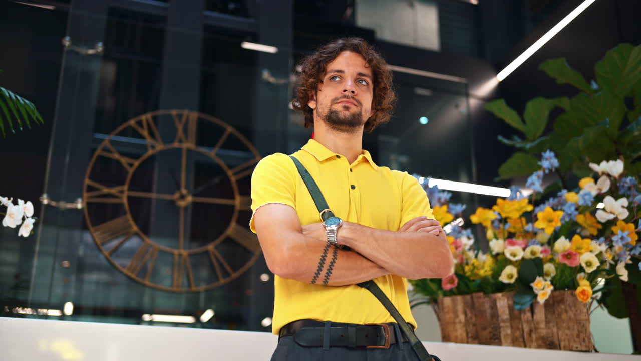 Man in yellow shirt standing in an office building