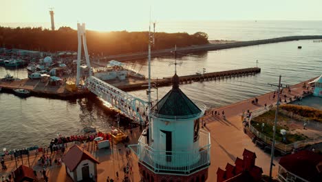 lighthouse and foot bridge in port