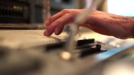 someone operating a vintage audio mixer