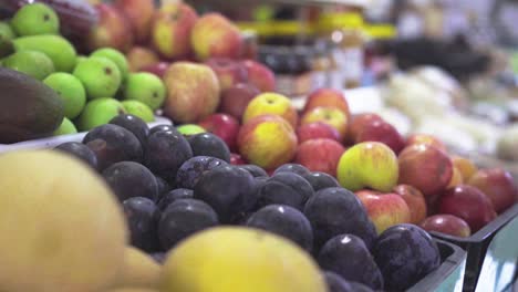 push out slow motion shot of fruit and vegetables in a farmer's market