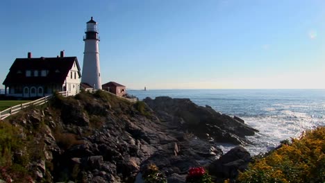 the portland head lighthouse oversees the ocean from rocks in maine new england  3