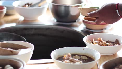 sequential preparation of noodle soup in bowls