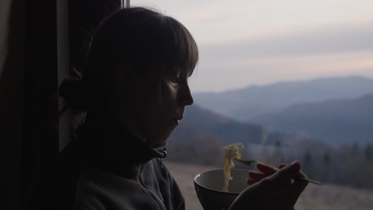 Woman drinking and looking out the window