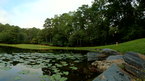 time-lapse of fisherman fishing along the shores of a lake, catching and releasing fish with conservation in mind