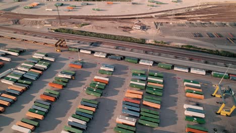 container handler driving above lined up containers