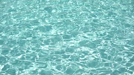 water surface texture, slow motion clean swimming pool ripples and wave, refraction of sunlight top view texture sea side white sand, sun shine water background. water caustic background.