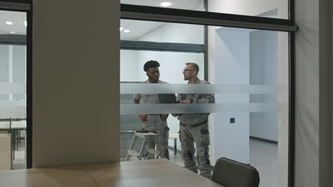 workers discussing work in a modern office.