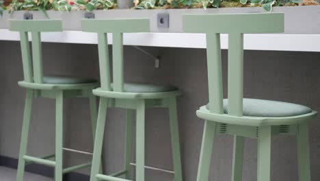 green bar stools at a modern cafe