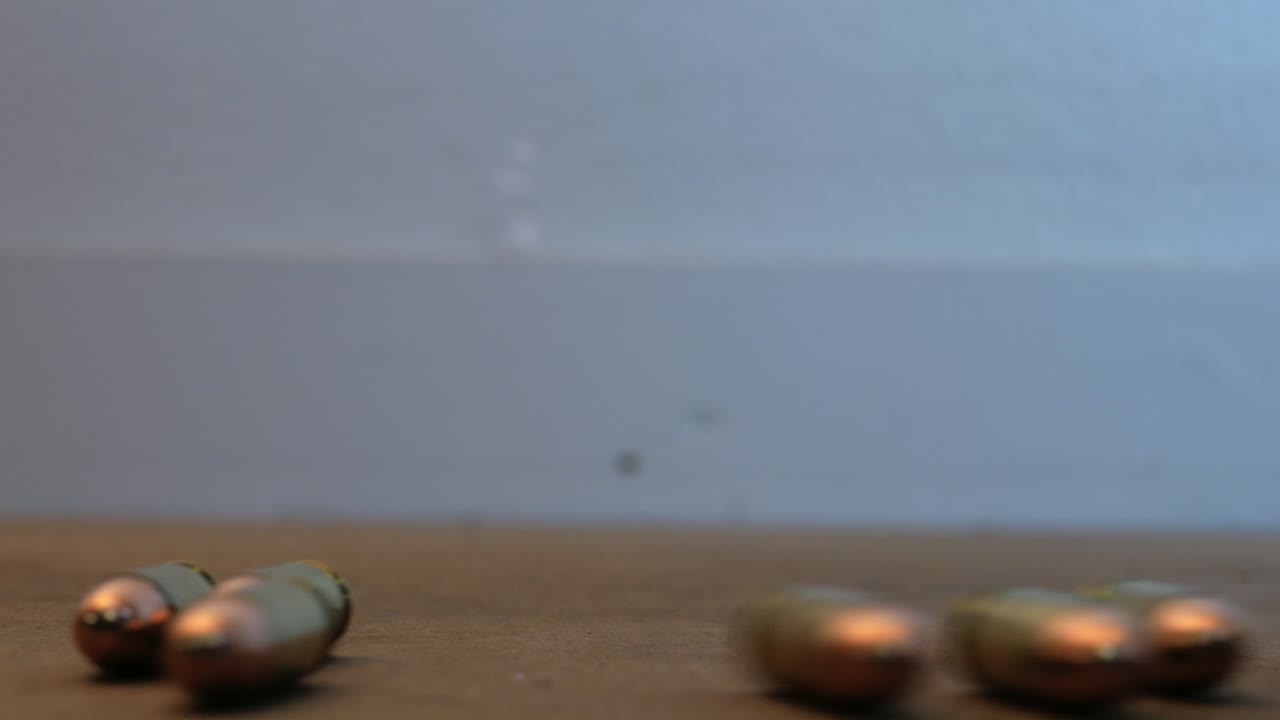 Dangerous large caliber ammo rolling on the table right to left