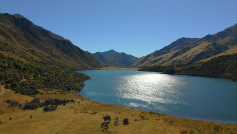 scenic moke lake near queenstown, new zealand glistening in sunlight, aerial view