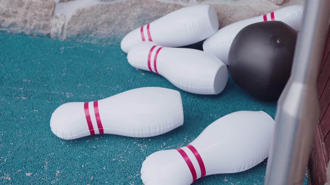 fun inflatable bowling game setup with toppled pins and soft ball