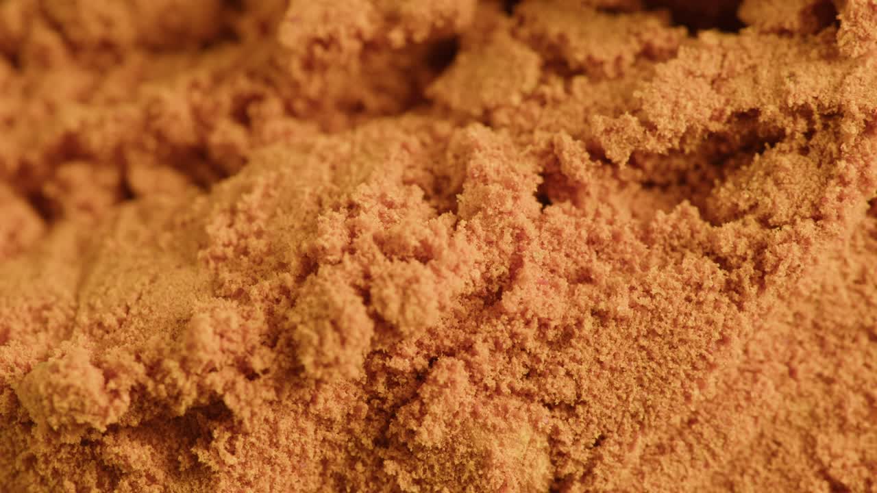 Close Up Macro Shot of Orange Brown Powder Texture