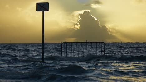 a static shot of a sea waves at the sunset time with yellow sky background on the north sea