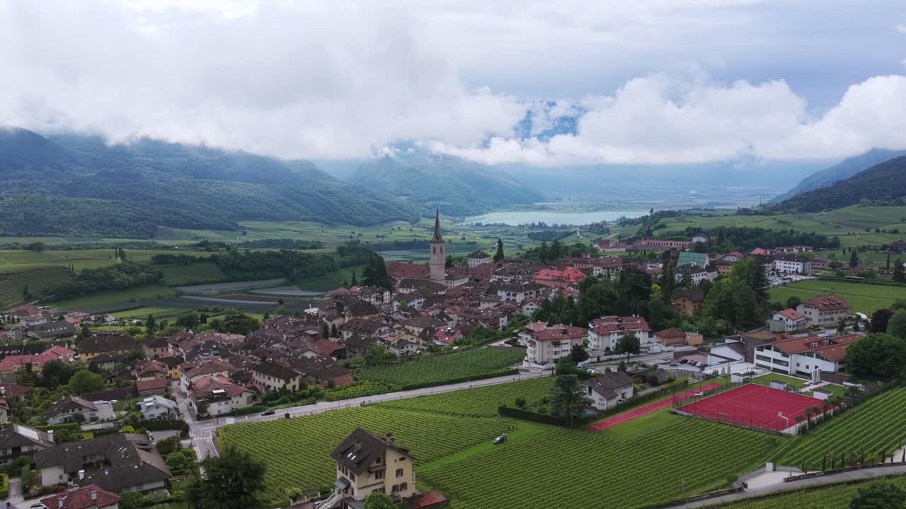 Caldaro Town And Fields With Mountain Views In Italy. - aerial shot