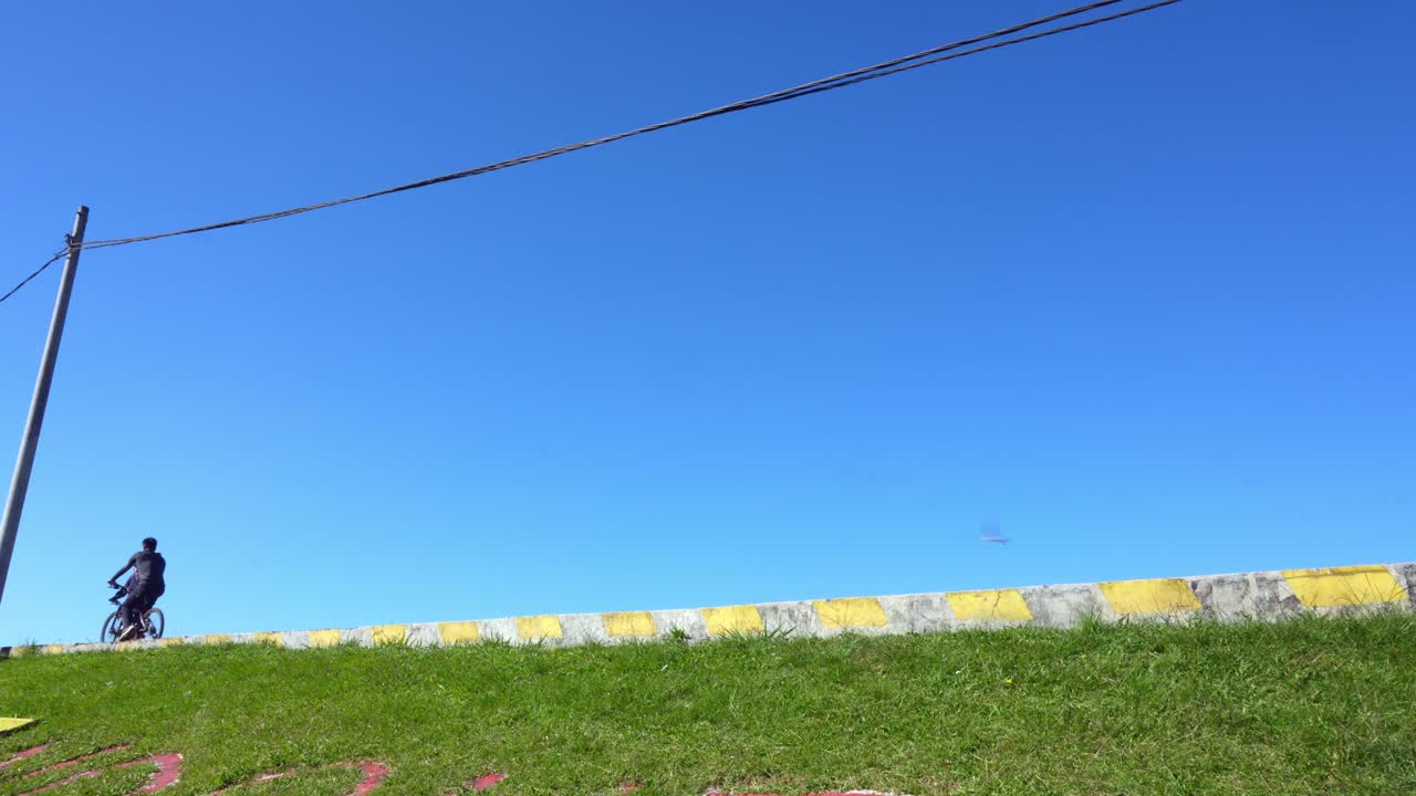 Side View Of Two Men With Bicycles Relaxed On Sunny Day With Clear Blue Sky