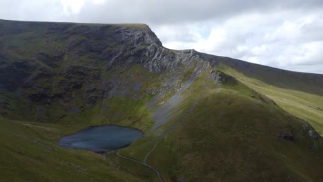 aerial 4k drone video of scales tarn and sharp edge mountain ridge on blencathra in lake district uk