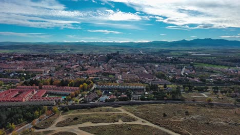 aerial view of avila, spain showcasing the city's historic architecture and walls, surrounded by autumn hues