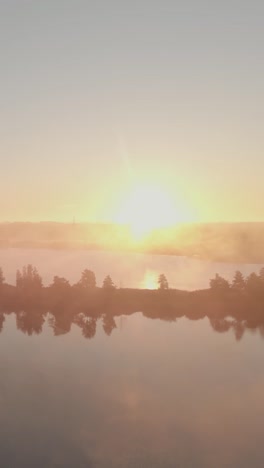 sunrise over a misty lake