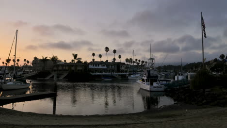 time lapse clouds at dusk blowing over channel lined with homes and boats