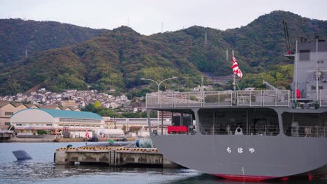 japanese navy flag flying on ship in kure harbor, hiroshima japan