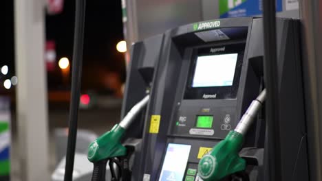 refueling station technology: a close-up look at gas pump interface and fuel nozzles during nighttime operation for efficient refueling experience