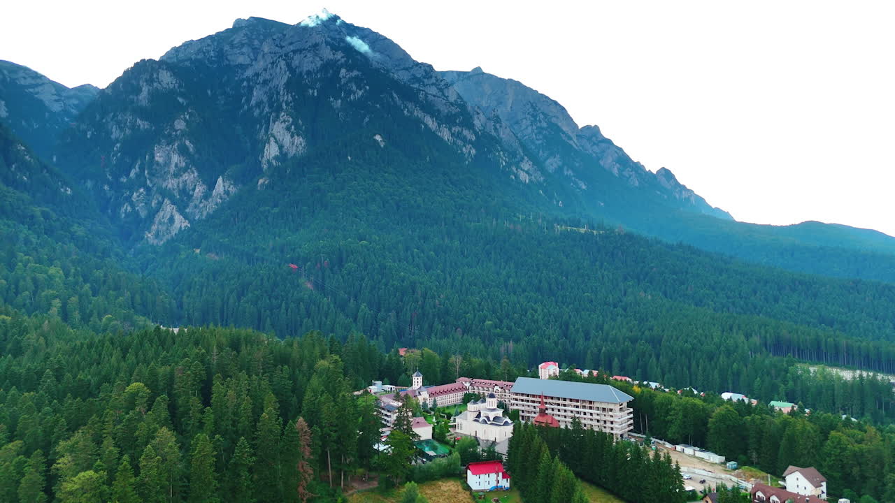 Buildings located on the rock surrounded by the woods. Jaw-dropping scenery of the Bucegi mountains, Romania