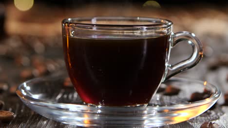pouring hot coffee into a glass cup