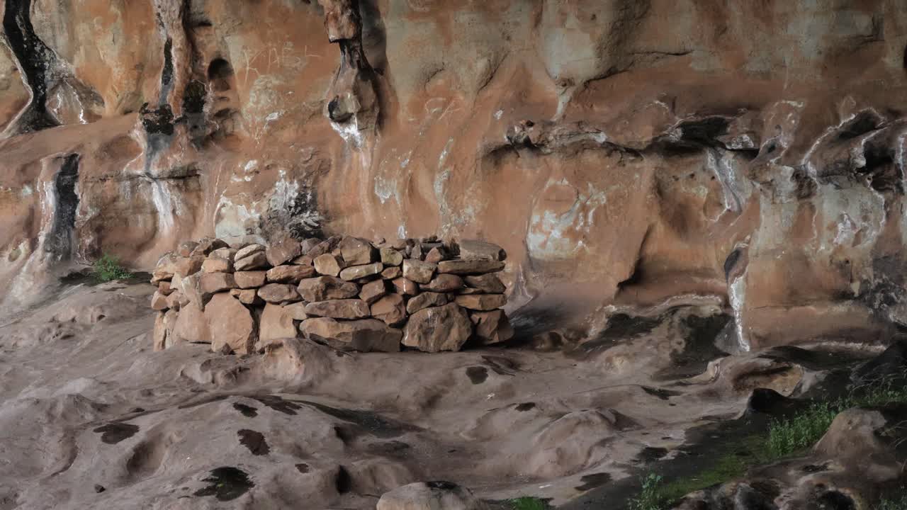 Round neolithic cave construction of stacked stones in ancient cavern