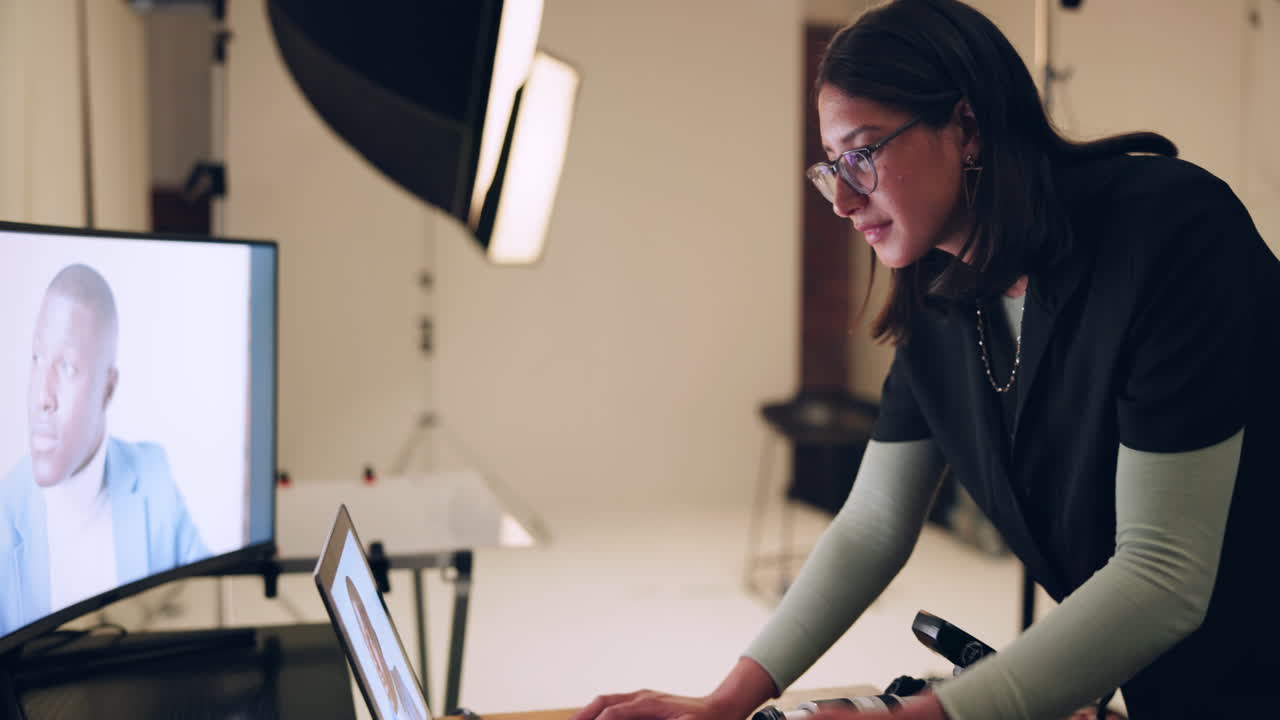 Photographer editing photos in a studio