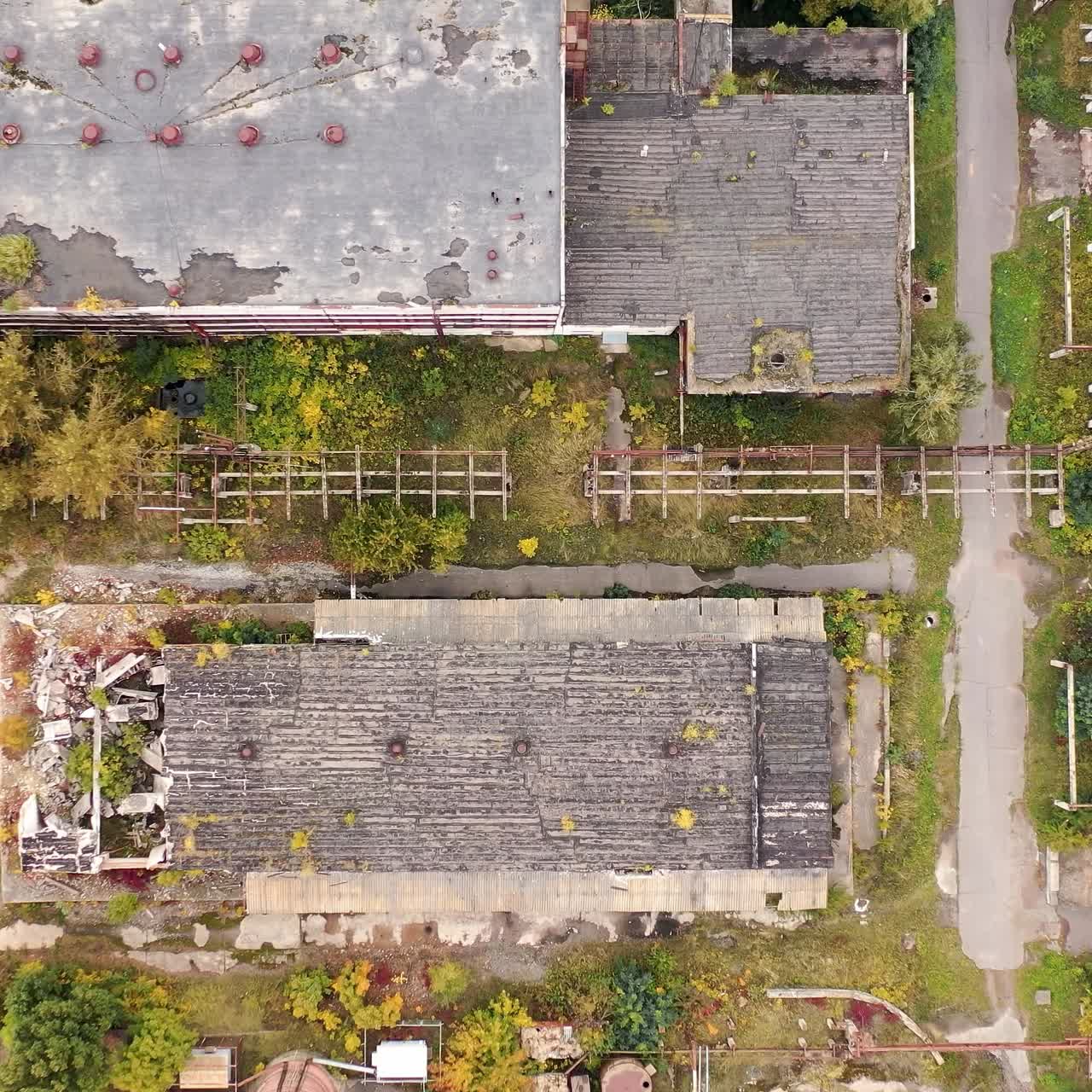 Abandoned destroyed factory territory. Old ruined empty industrial architecture