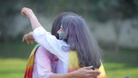 indian girls celebrating holi in a park