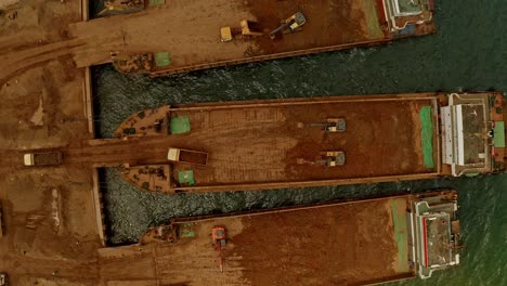 top down view of mining barges being loaded in taganito, claver, philippines