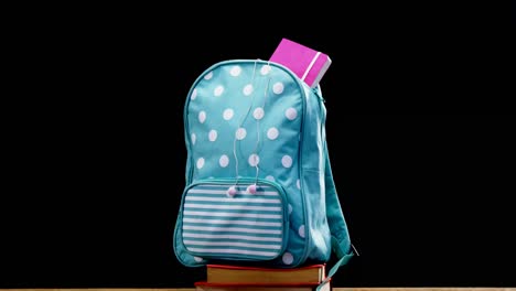 schoolbag on book stack