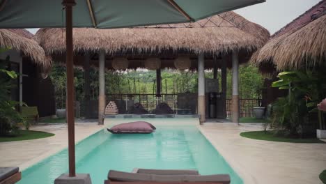 amazing balinese style hut resort, turquoise pool.