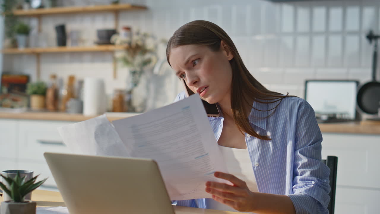 Busy entrepreneur talking cellphone working laptop at home office closeup