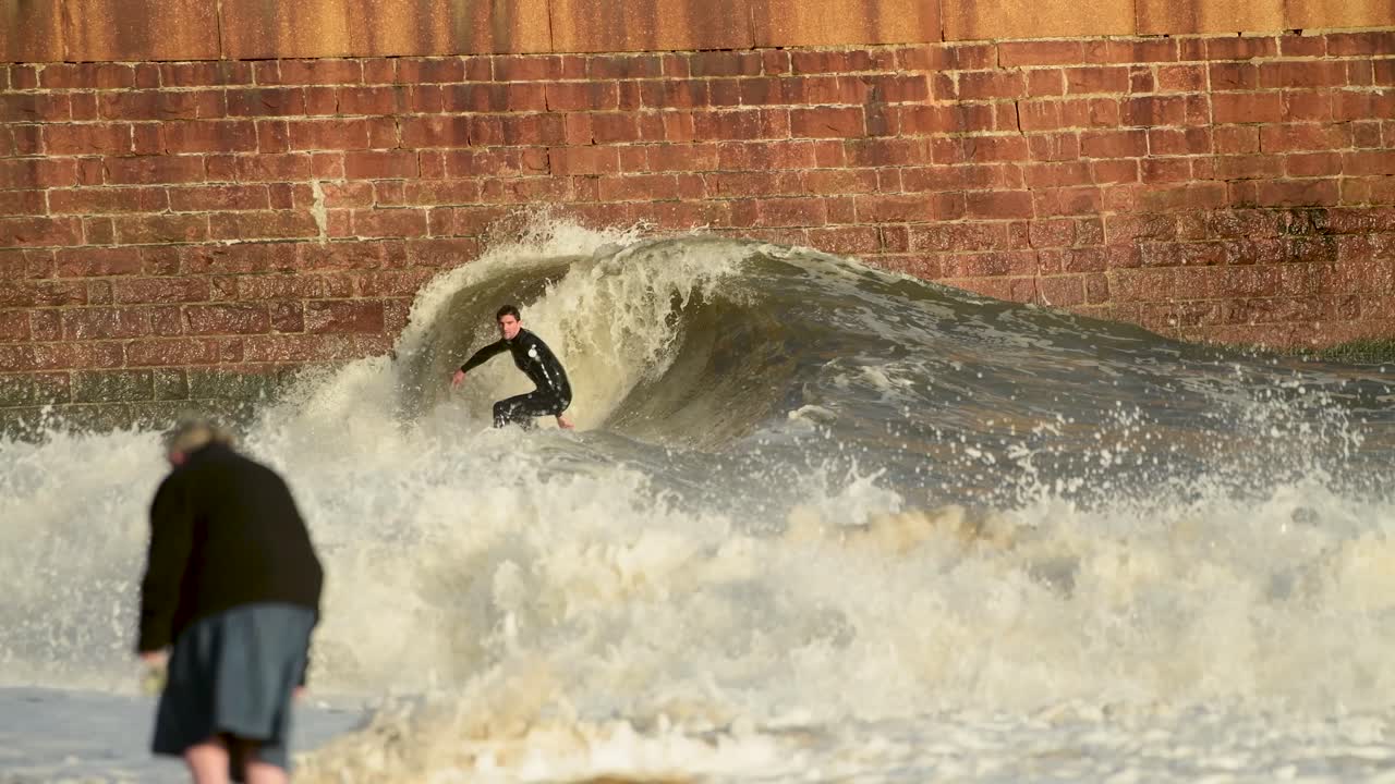 영국 북동부에서 서핑하는 로커 비치의 등대 피어에서 파도를 잡는 항공 서퍼