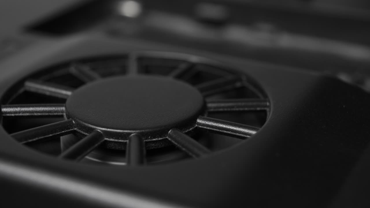 Intermittent rotation of the blades of a black damaged plastic fan