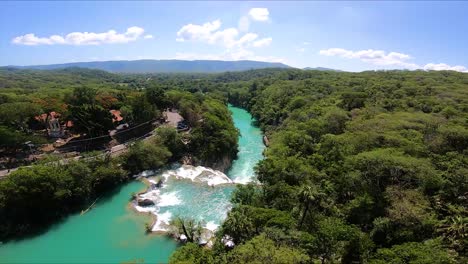 aerial view of lush rainforest river and waterfall