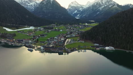 Mountains-And-Village-On-The-Shores-Of-Lake-Achensee-In-Tyrol,-Austria---aerial-drone-shot