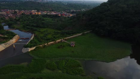 stunning aerial of the beautiful eleyele river surrounded by green vegetation in ibadan, nigeria.
