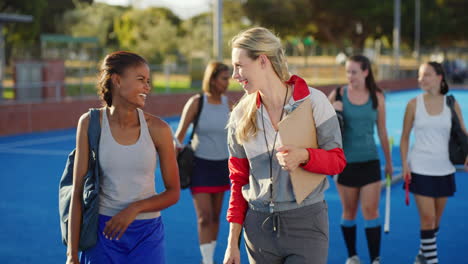 playful female hockey coach talking to a young