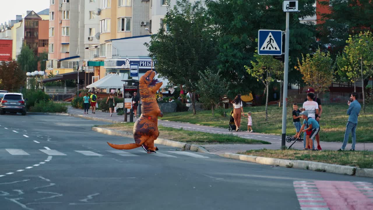 Unrecognizable person in dinosaur costume. Tyrannosaurus costumes walking through the city