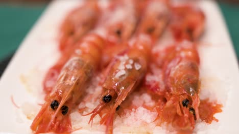 Homemade-oven-cooked-seafood-red-shrimp-dish-on-a-pristine-white-platter-and-garnished-with-a-sprinkle-of-sea-salt