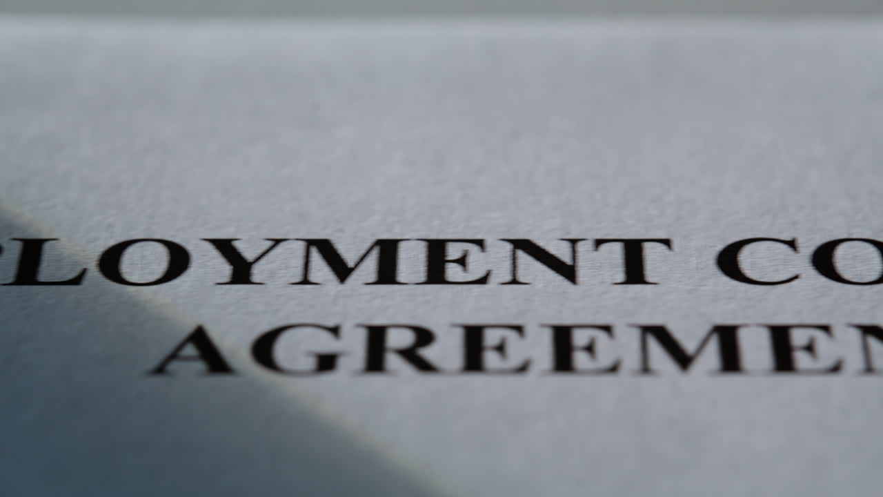 Closeup employment contract agreement document. Detailed paper in daylight area