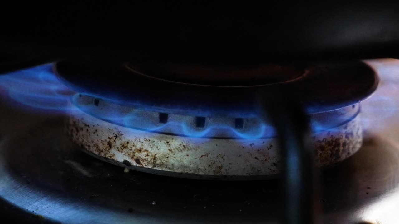 Lighting up (igniting) gass stove in close up shot. Domestical kitchen concept